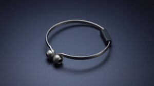 A single pair of bone conduction headphones resting on a smooth matte surface against a deep navy background. The open-ear titanium wraparound band curves elegantly, with small transducer pads visible at each end. Soft directional side lighting catches the metallic sheen and subtle texture of the frame, casting a gentle shadow that grounds the minimal composition.